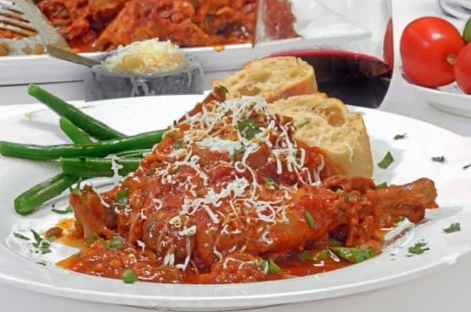 a plate of food with bread and chicken cacciatore