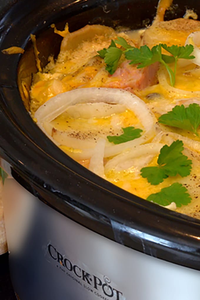 Crockpot full of scalloped potatoes and ham and cheese.