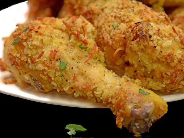 a crispy chicken drumstick on a plate.