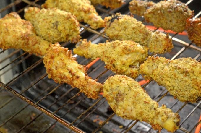 crispy chicken drumsticks on a grill.