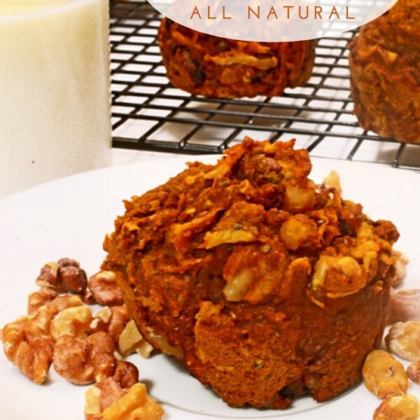 pumpkin muffin on a plate with a glass of milk.