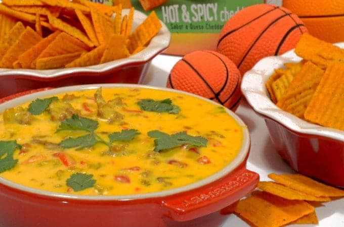 A bowl of food on a plate, with Cheez-It and Cheese