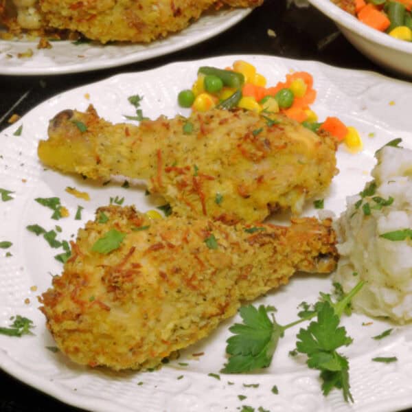 A plate of fried chicken drumstics.