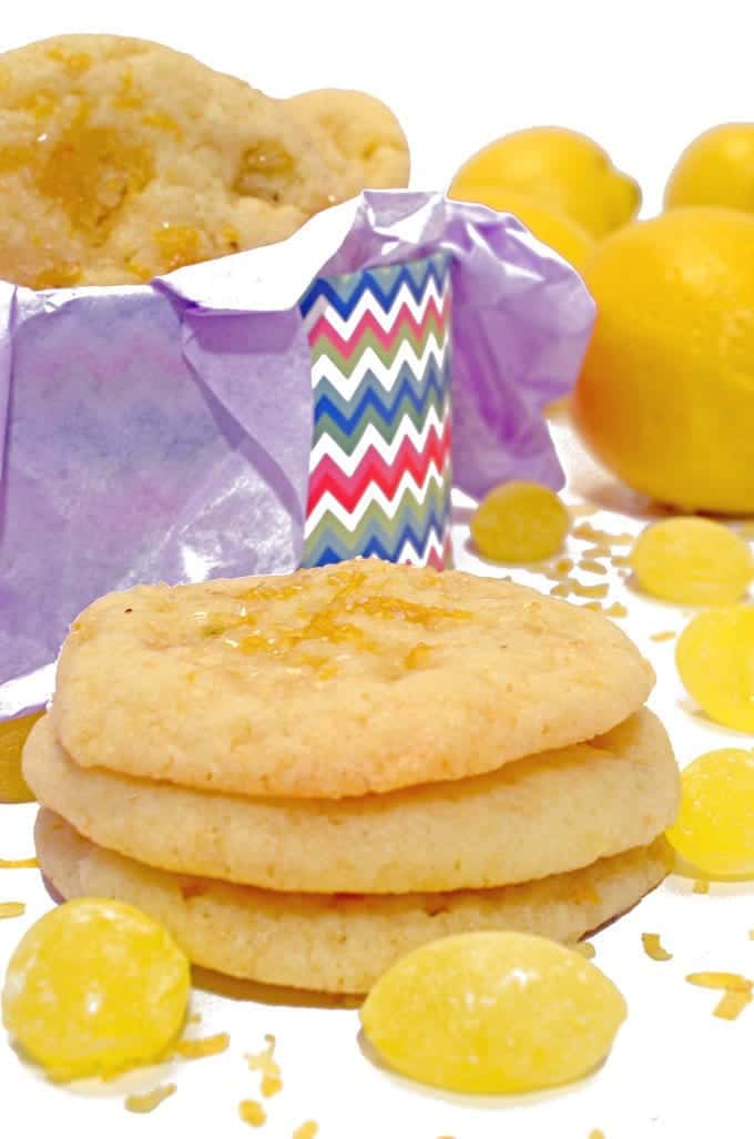 three lemon drop cookies stacked on top of each other.