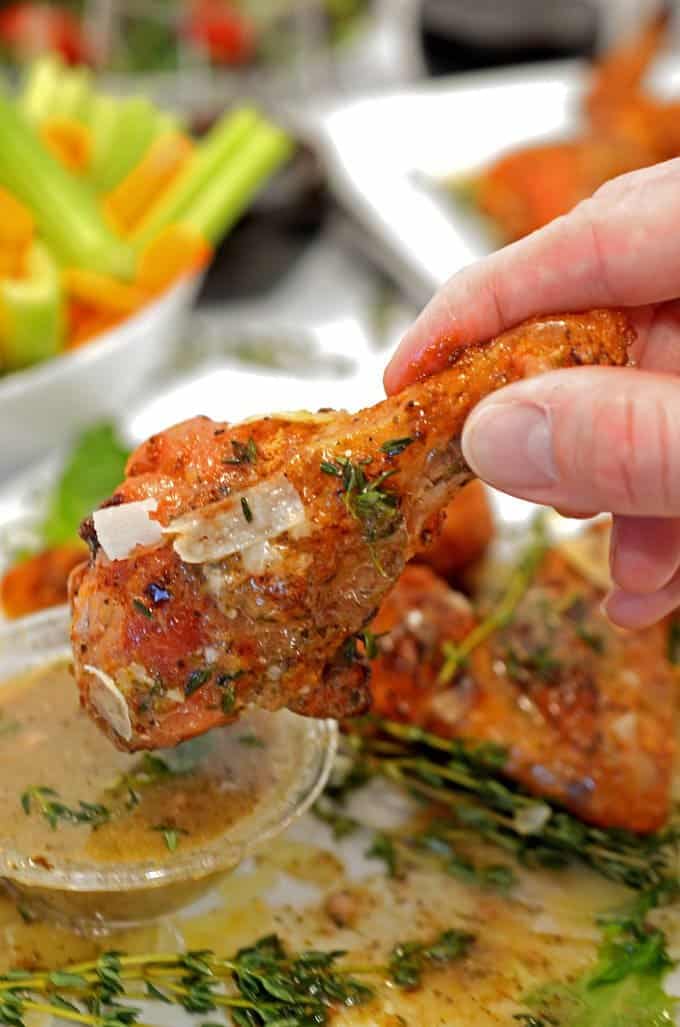 Dipping a chicken wing in sauce