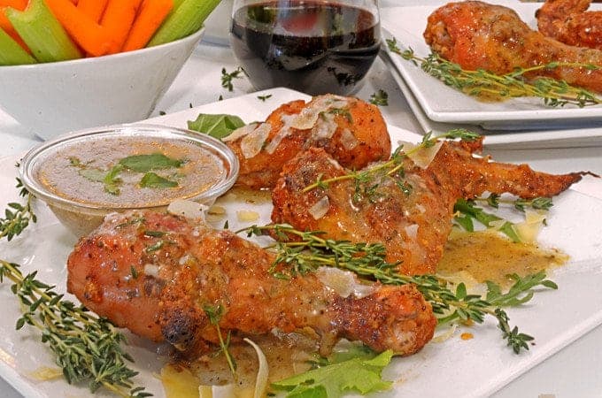 A plate of food on a table, with chicken wings