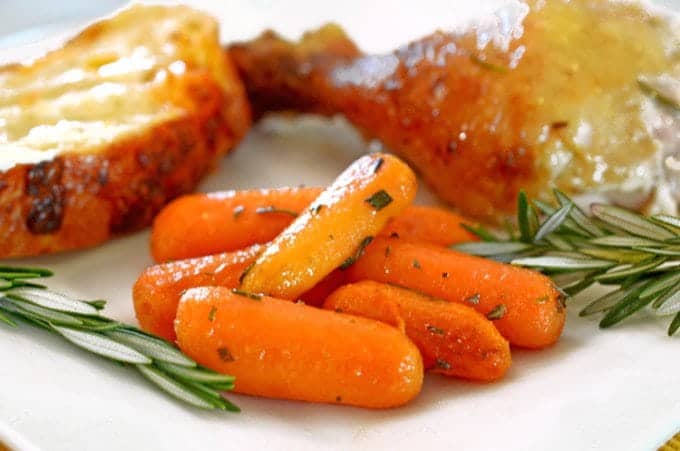 A plate of food with roasted baby carrots