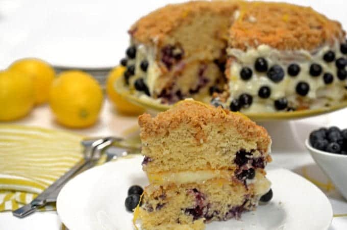 A piece of cake on a plate, with Blueberry and Cream