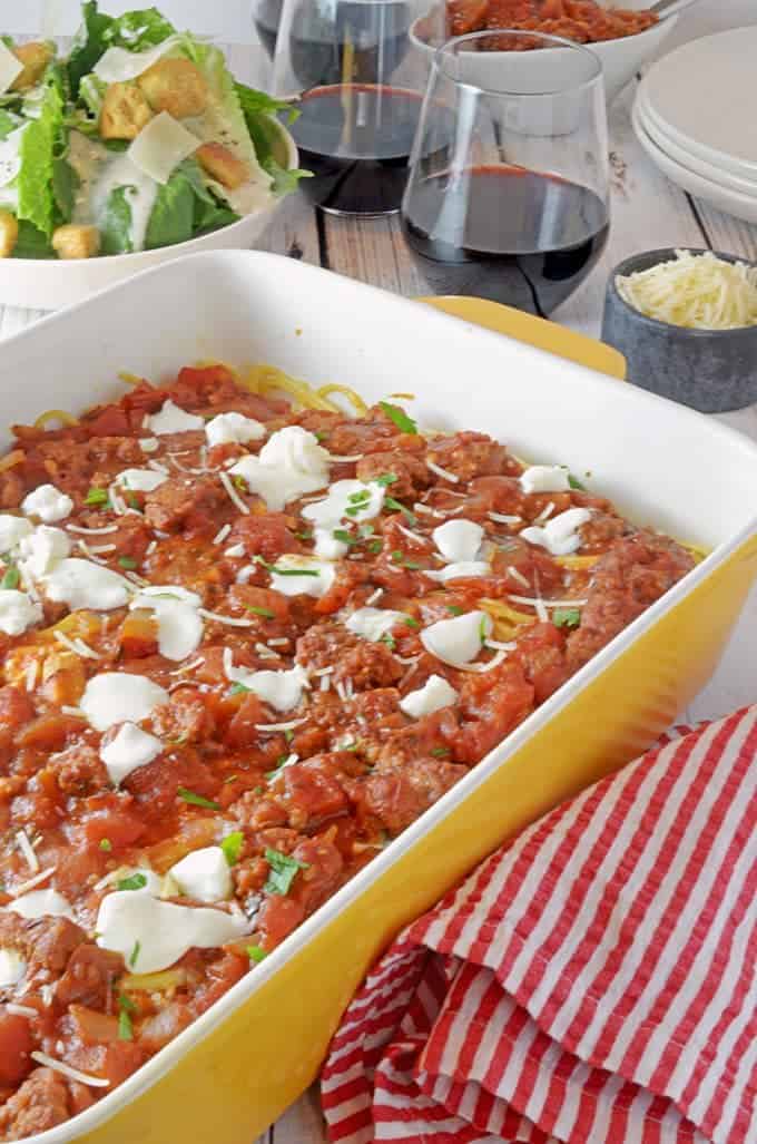 A bowl of food on a table, with Spaghetti and Sauce