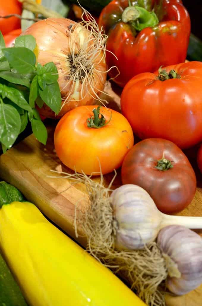 A bunch of tomatoes and vegetables.