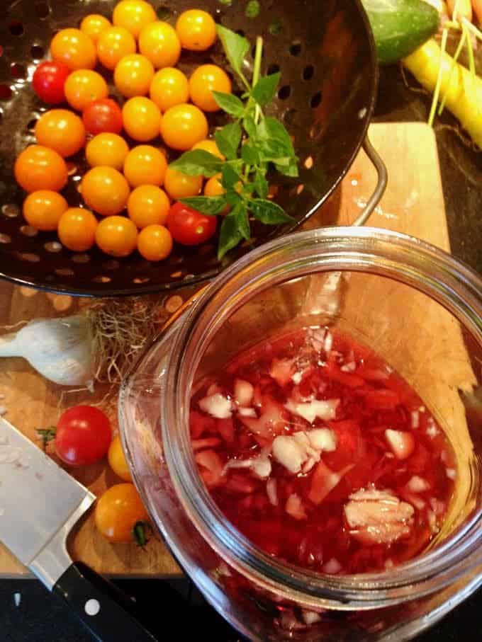 marinating cherry tomatoes in a bowl