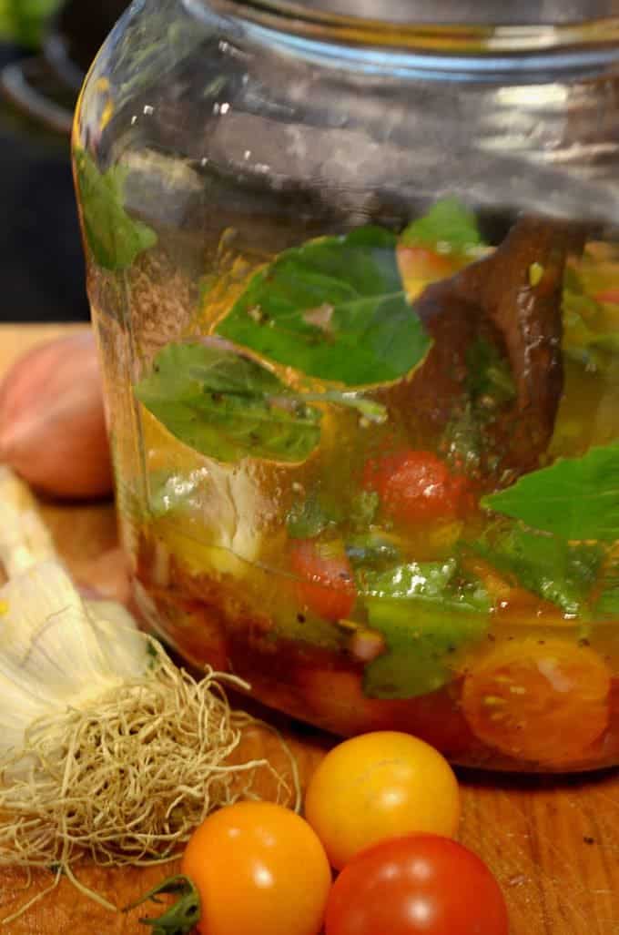 tomatoes marinating in a bowl