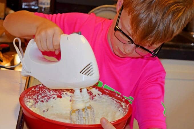 A boy mixing ingredients in a bowl
