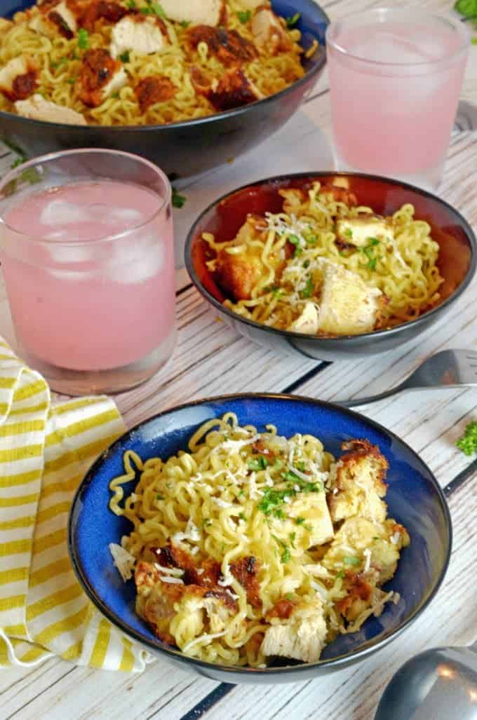 Serviong bowl of chicken ramen noodles with two glass of lemonade.