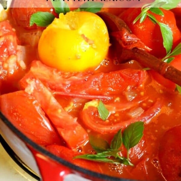 Pot of simmering ingredients for tomato sauce.