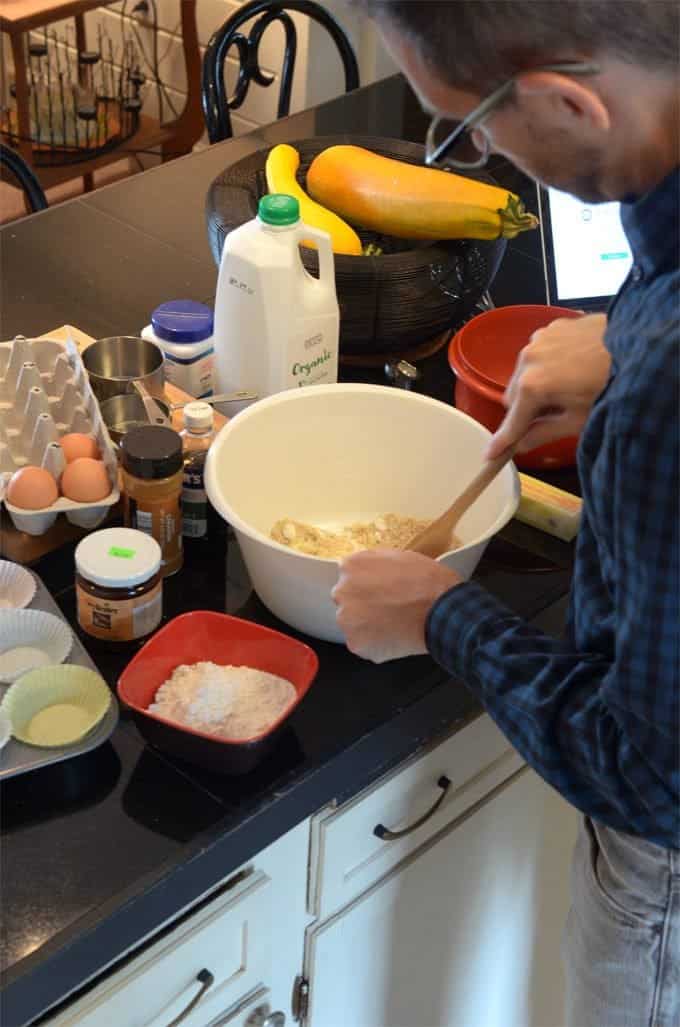 A man preparing food in a kitchen, with Apple and Butter