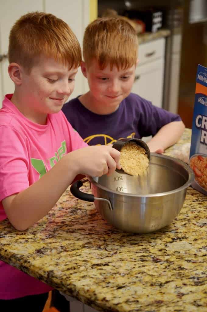 Two boys making a dessert