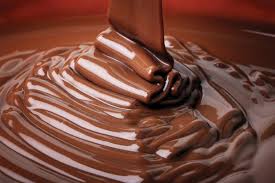 A bowl of chocolate being drizzled