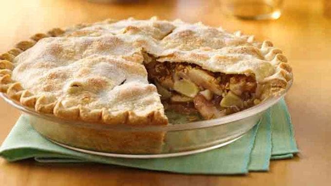 A pie in a dish with a slicer cut out