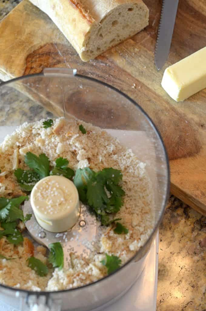 Food processor containing butter, crumbs and parsley