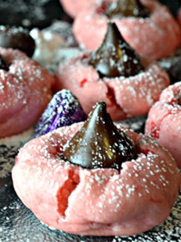 A cherry cookie with a Hershey's kiss in the middle.