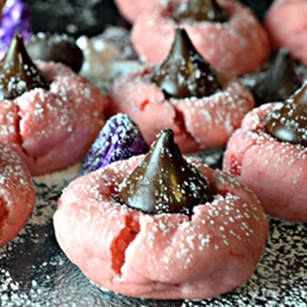 A cherry cookie with a Hershey's kiss in the middle.