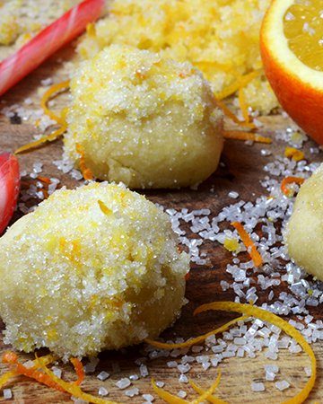 three orange snowball cookies