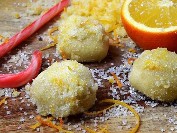 three orange snowball cookies