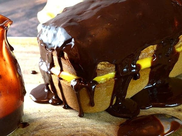 A cake drizzled with chocolate frosting