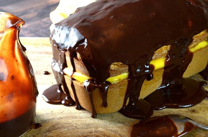 A cake drizzled with chocolate frosting