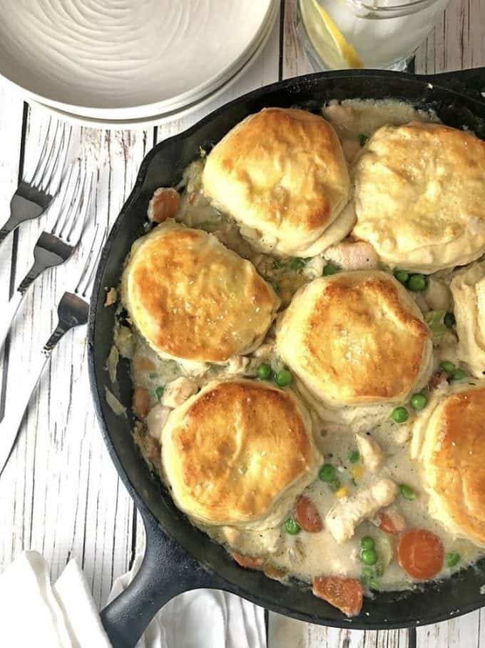 cast iron skillet of chicken and biscuits pot pie.