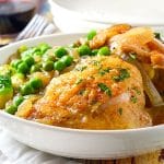 A bowl of food on a plate, with Chicken