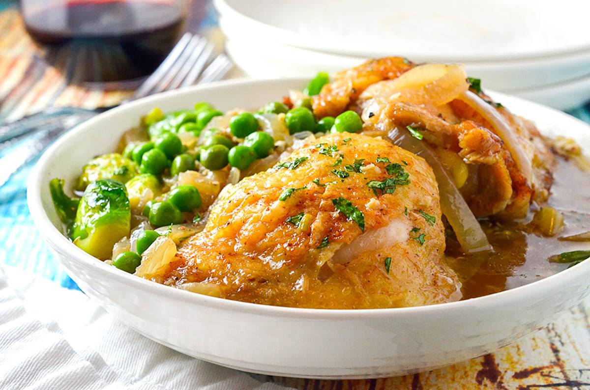 A bowl of food on a plate, with Chicken Thighs