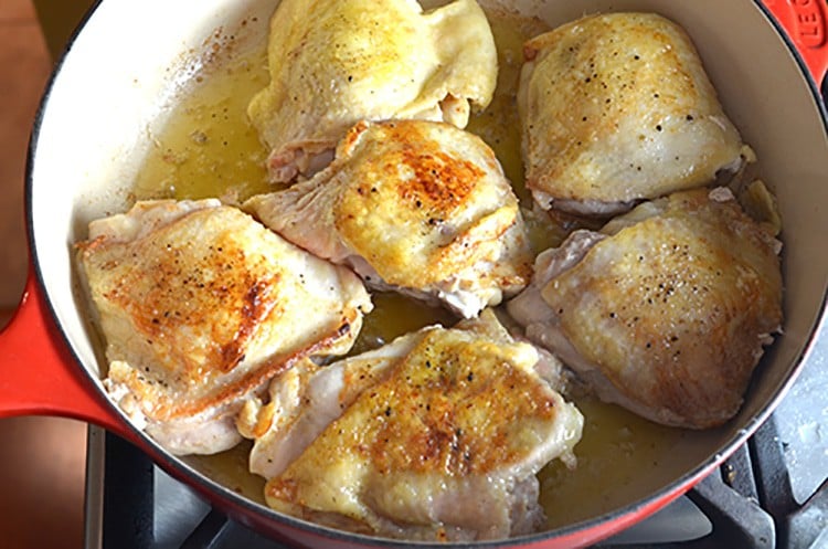 Seared chicken thighs in a skillet