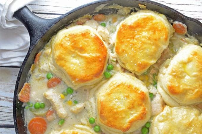 Cast iron skillet with chicken and biscuits pot pie.
