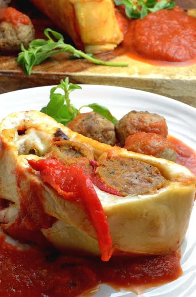 A close up of a plate of food, with Meatball and Stromboli