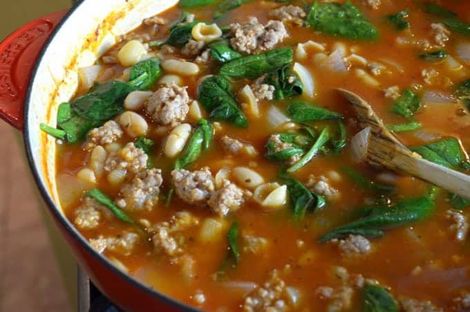 Making bean and sausage soup in a Dutch oven