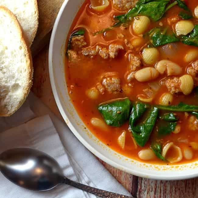 A bowl of soup with bread on the side