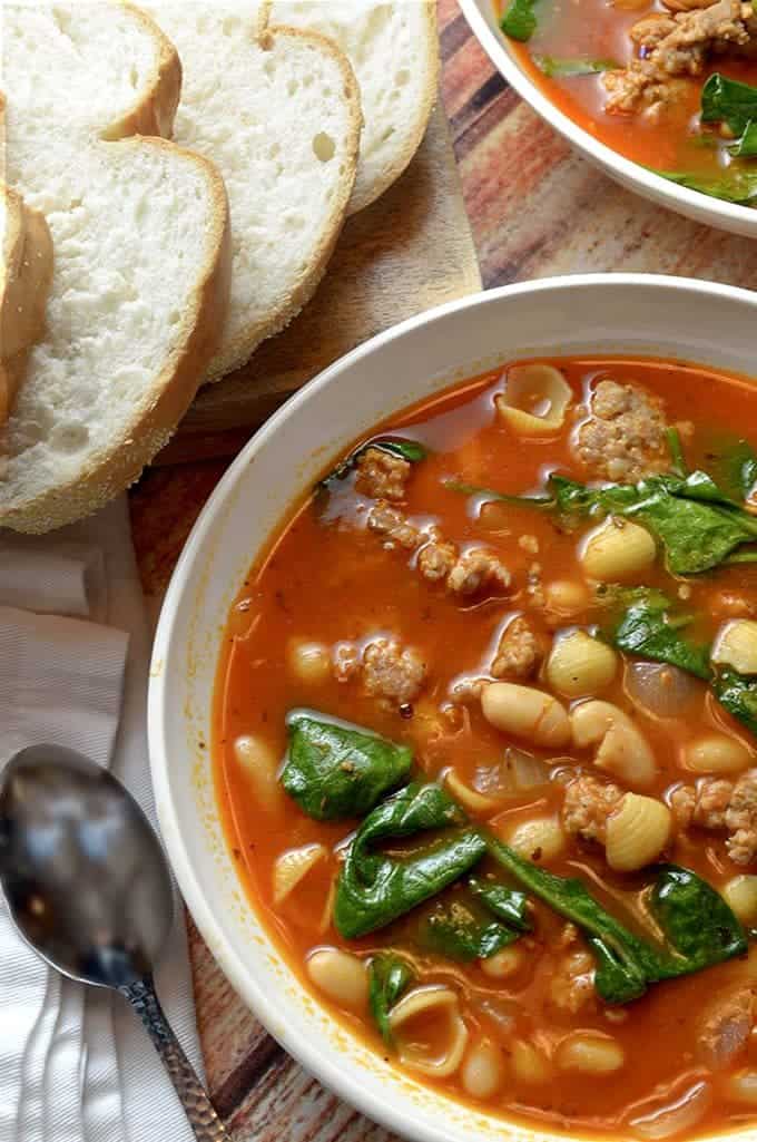 A bowl o soup with white beans and sausage