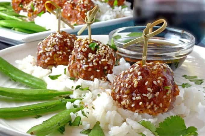 Asian meatballs atop rice and vegetables