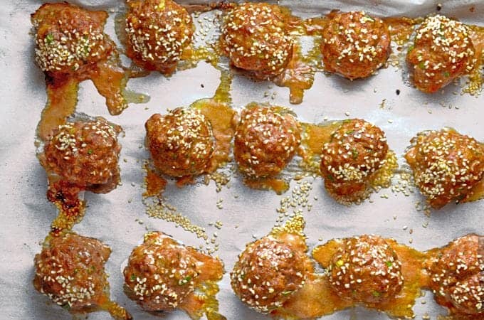 A close up of prepared Asian meatballs on tray