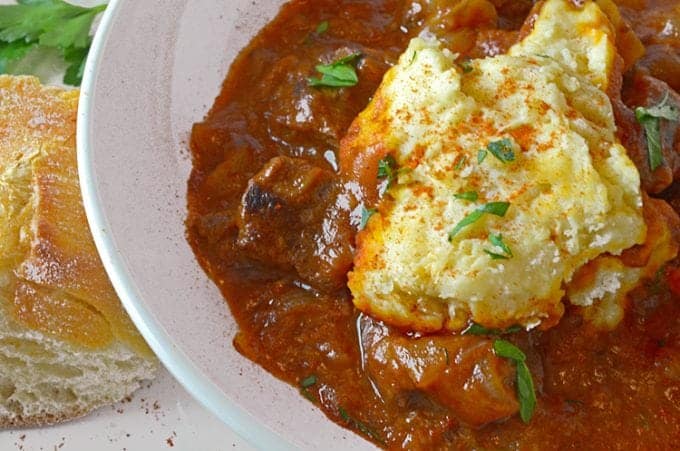 A close up of a plate of food, with Goulash and Dumpling