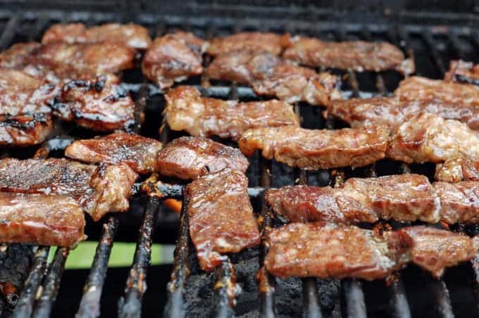 A close up of food on a grill, with Grilling and Beef