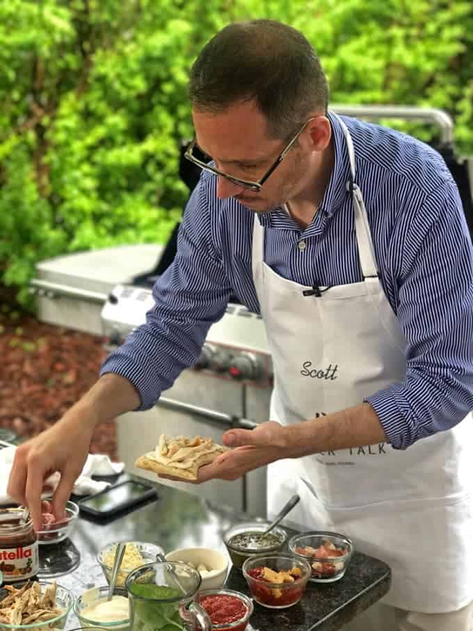 A man preparing food on a table, with Pizza and Grilling