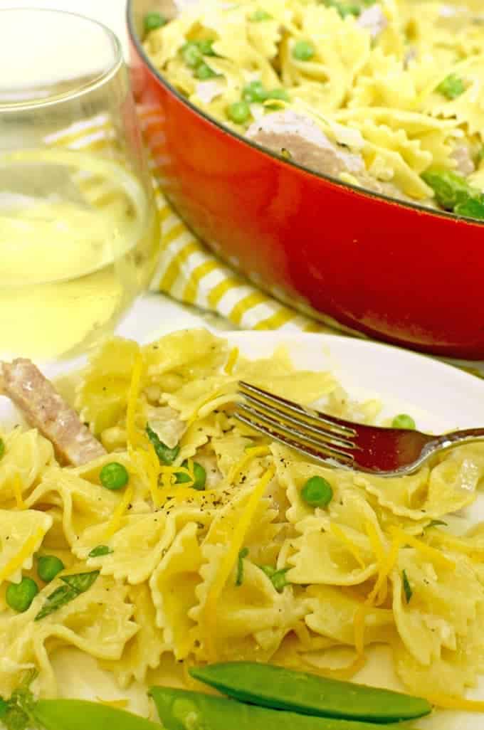 Pasta with peas on plate with fork