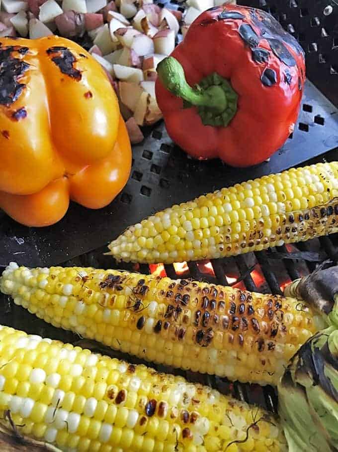 two bell peppers and three ears of sweet corn