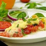 Plate of tomato pie with salad.