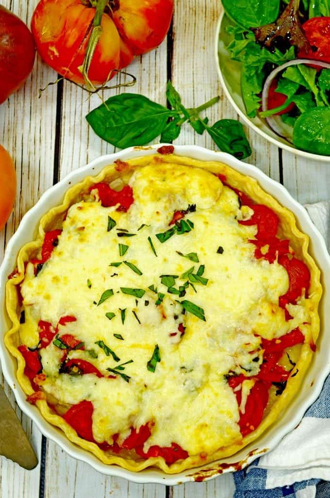 A tomato pie with basil garnish