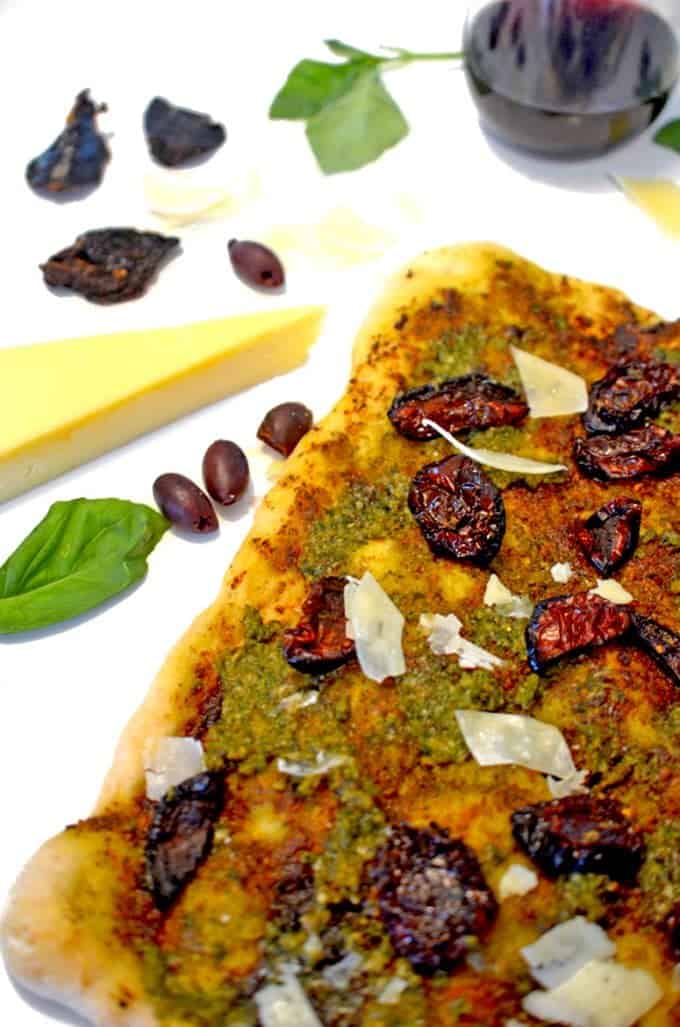 a sheet of pizza with assorted ingredients