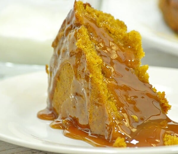 Slice of slow cooker pumpkin cake with caramel suace.